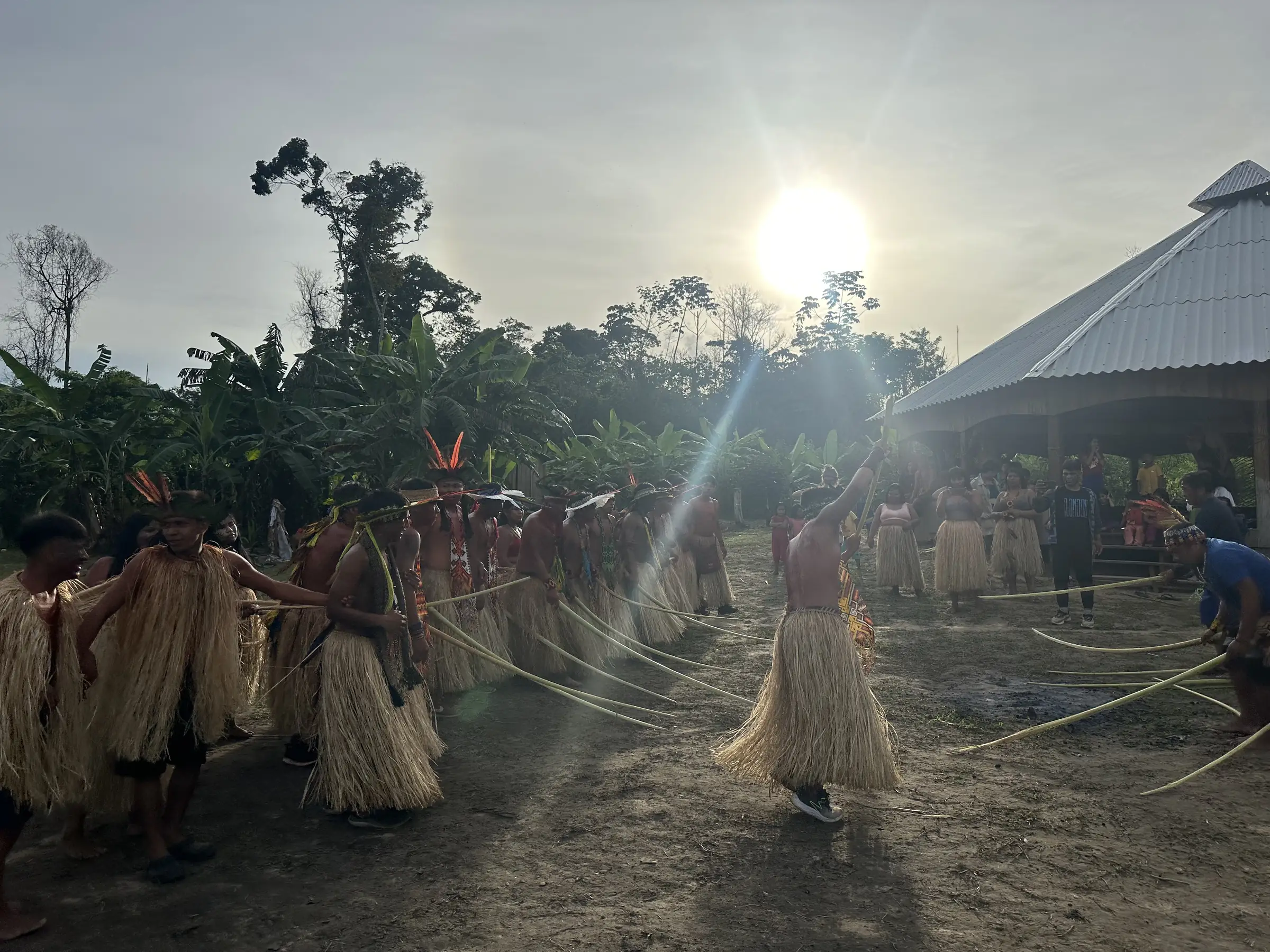 A community dance in an Indigenous village in the Amazon, at sunset