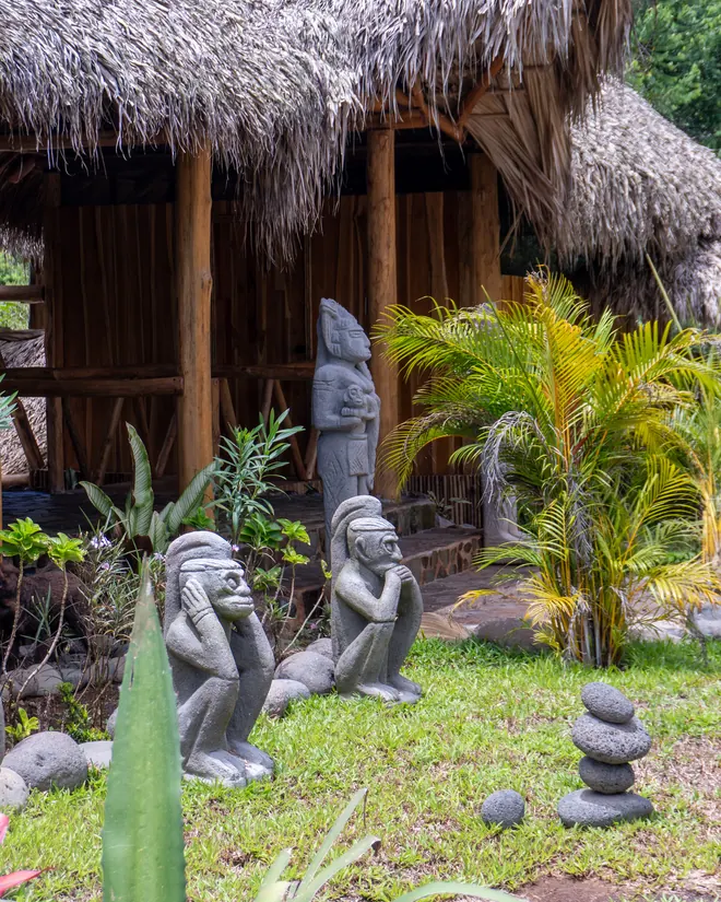 Stone statues in the garden between the cabins