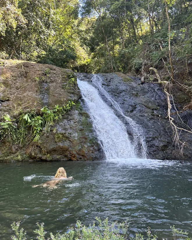 Swimming beneath a waterfall