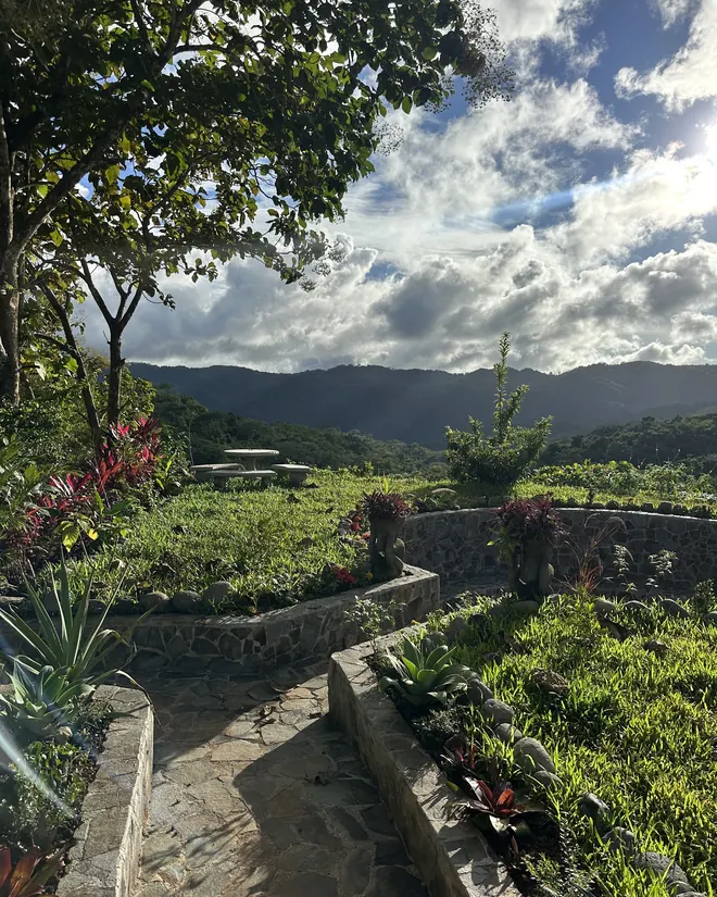 A stone circle in the gardens, the mountains behind