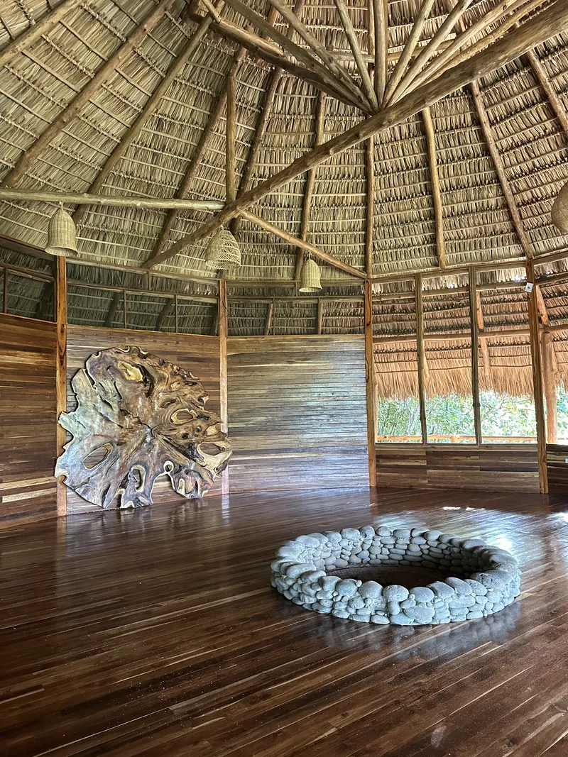 The fire circle and wooden floor inside the Maloca