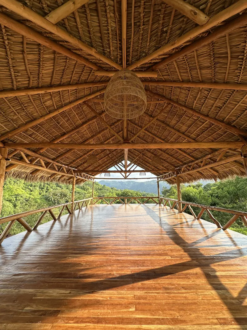 The open yoga shala, its wooden floor facing the mountains