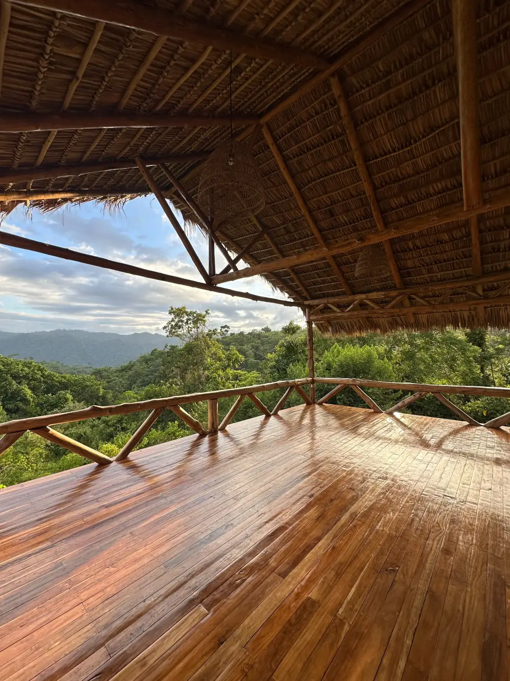 The yoga shala, wooden floor open to the canopy
