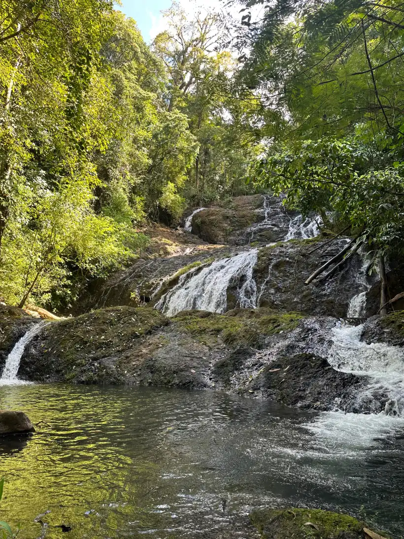 Waterfall cascading into a swimming hole